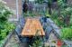 Outdoor dining area defined by gabion cage garden walls